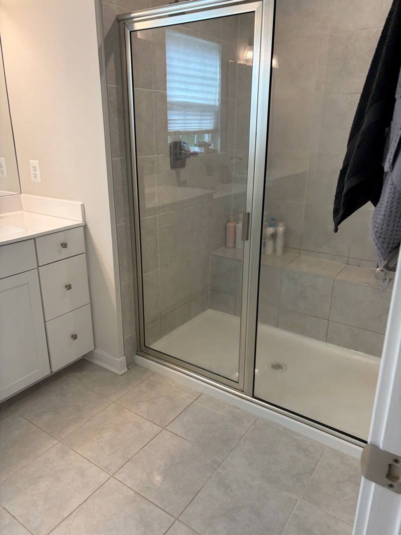 Bathroom shower with sparkling glass and tile after a deep clean