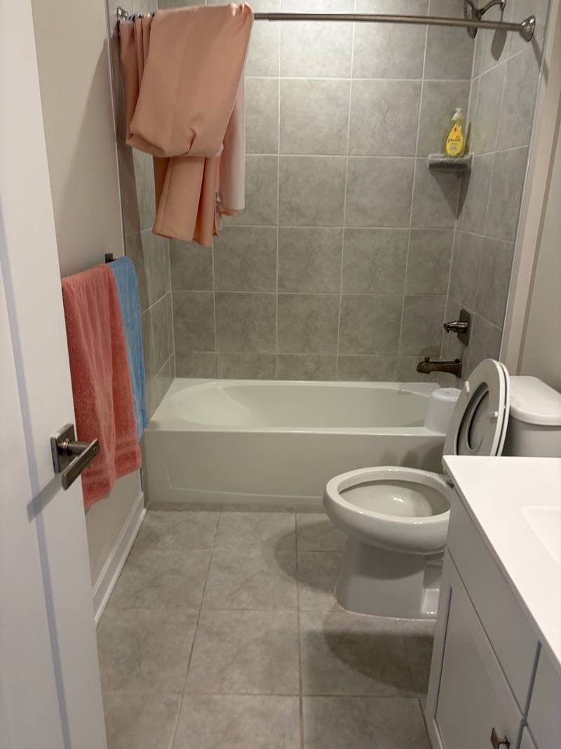 Bathtub and tile surround scrubbed during a deep house cleaning