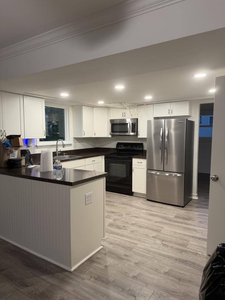 Kitchen with stainless steel appliances and cleaned countertops after a move out clean