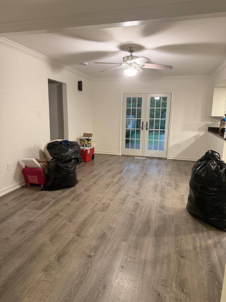 Open floor plan with clean vinyl plank floors after a move cleaning