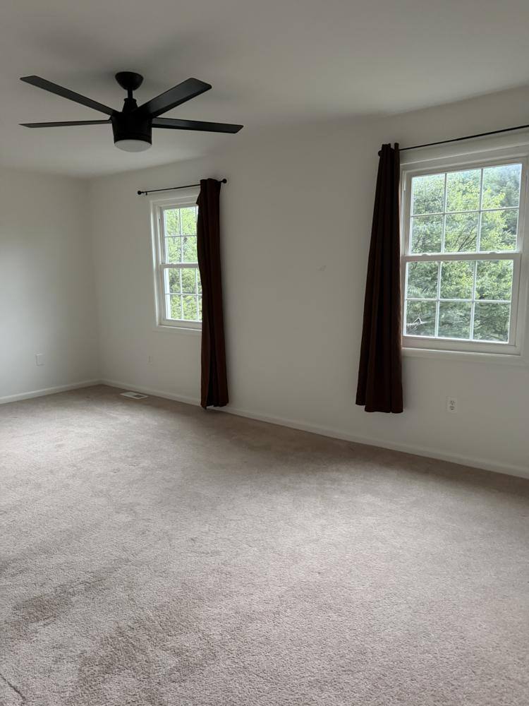 Vacant bedroom with vacuumed carpet after a move out clean
